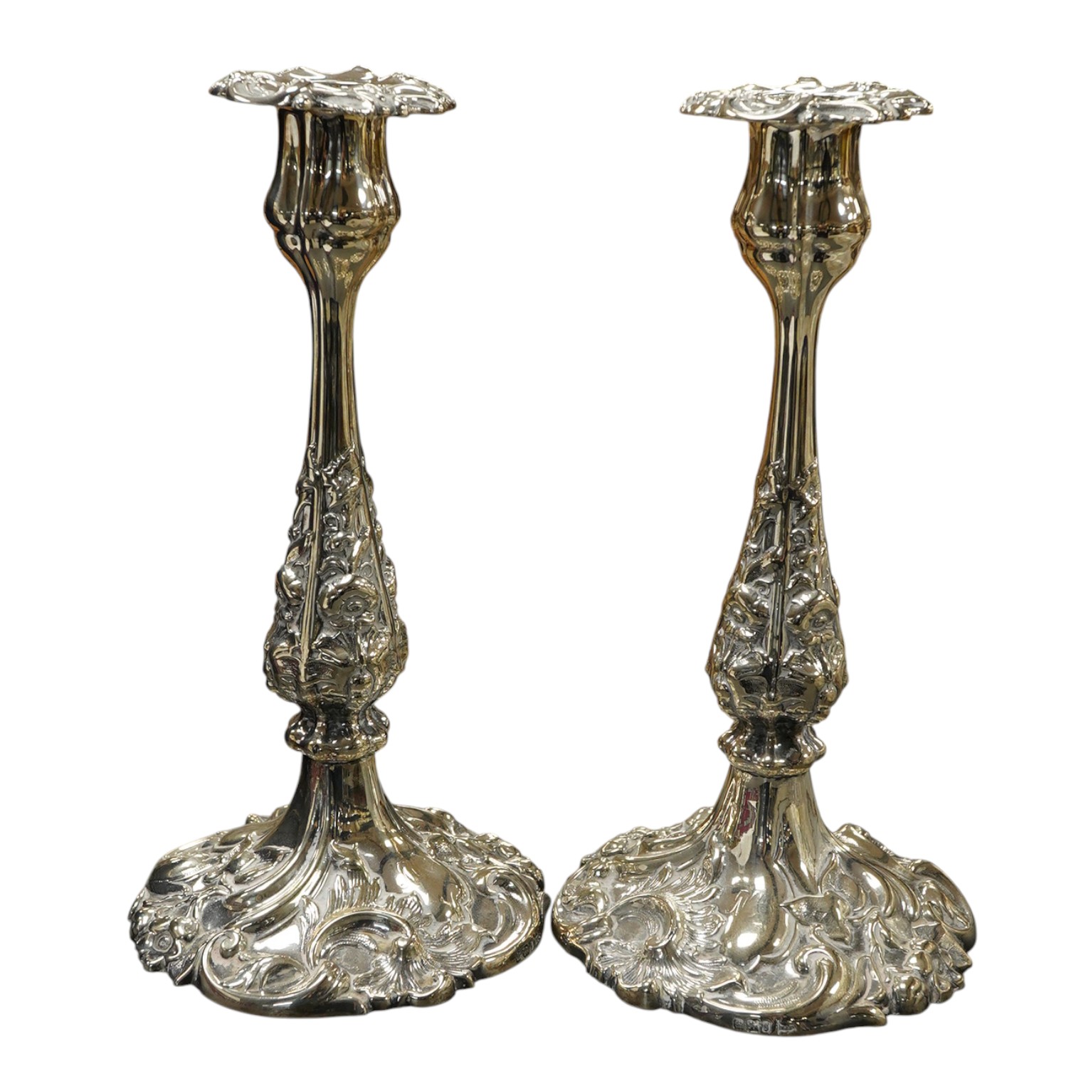 A pair of late Victorian silver candlesticks, with foliate decoration, by Walker & Hall, Sheffield, 1899, height 23cm, weighted.